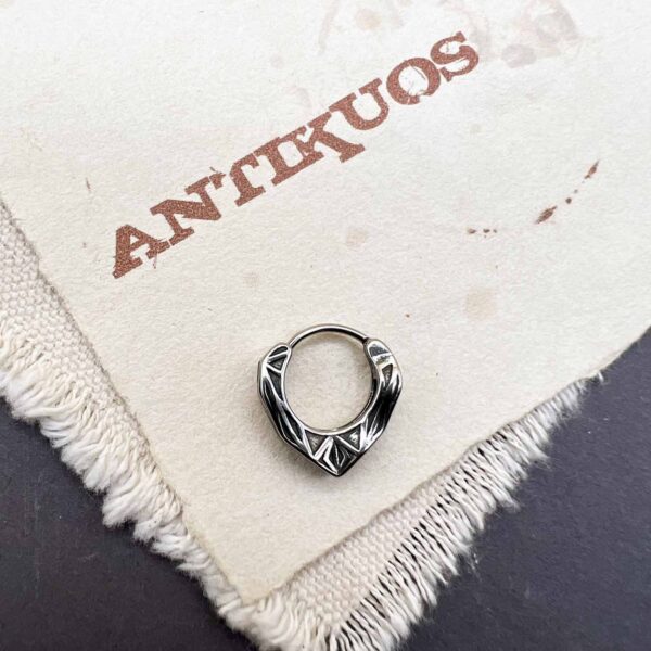Silver ring on textured paper background